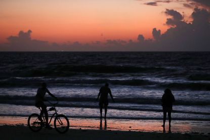 People gather to watch the sunrise as Hurricane Dorian approaches Florida on August 31, 2019 in Cocoa Beach, Florida. 