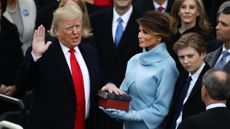 Trump with his hand raised as he is sworn in during his first inauguration in 2017