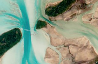 A cropped, close-up look at a jet photographed flying by Great Exuma Island in the Bahamas, as seen from space on July 15, 2015.