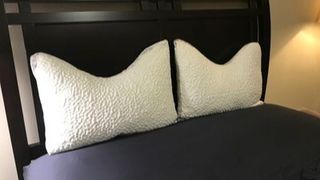 Two white Nest Bedding Easy Breather Pillows side by side on a made bed