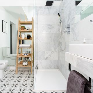 bathroom with printed tiles and wooden shelves