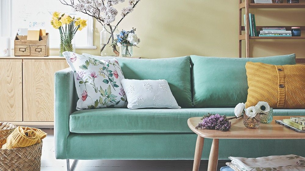 living room with wooden flooring and sofa set with cushions and storage shelves