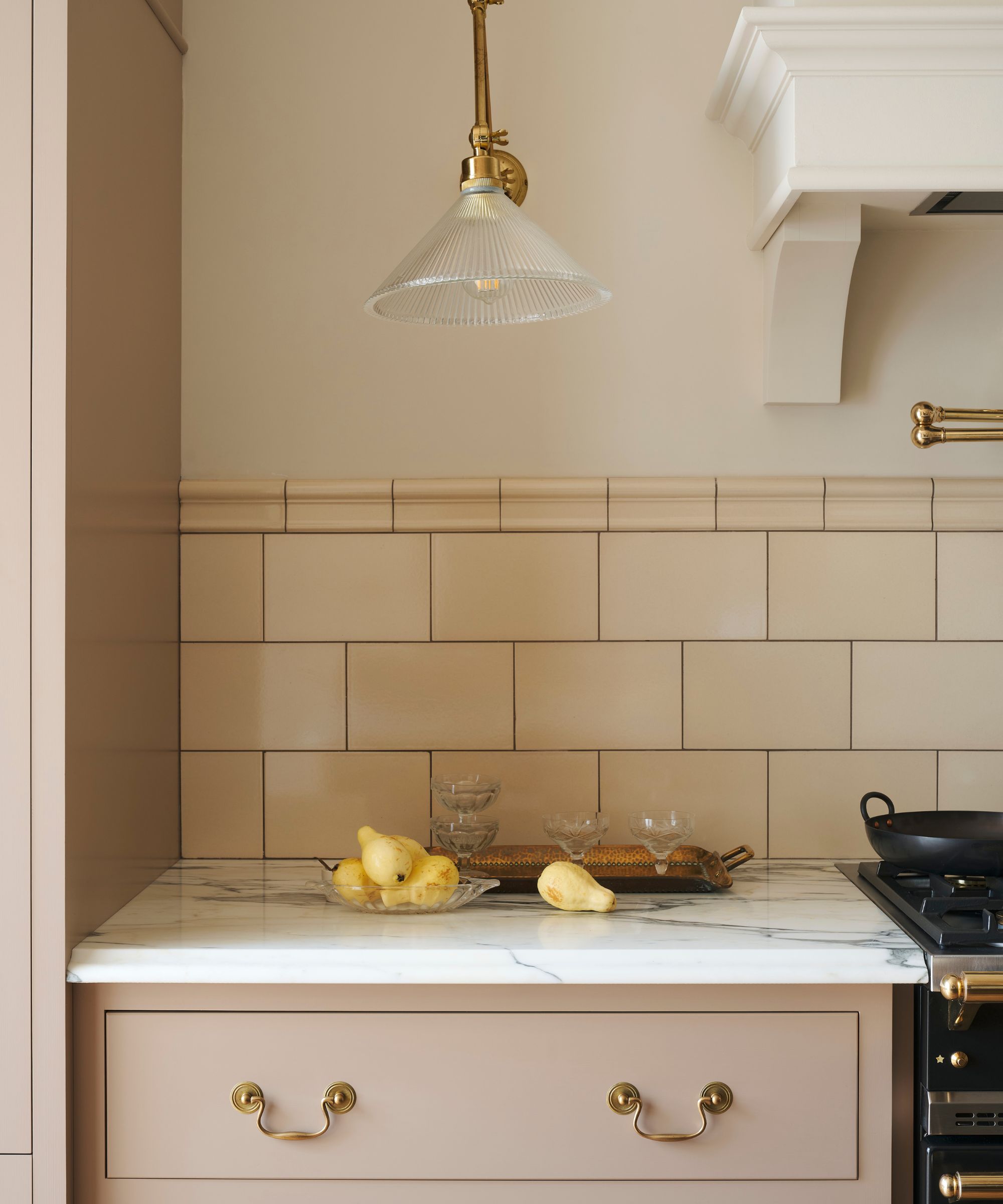 A pink kitchen with decorative hardware