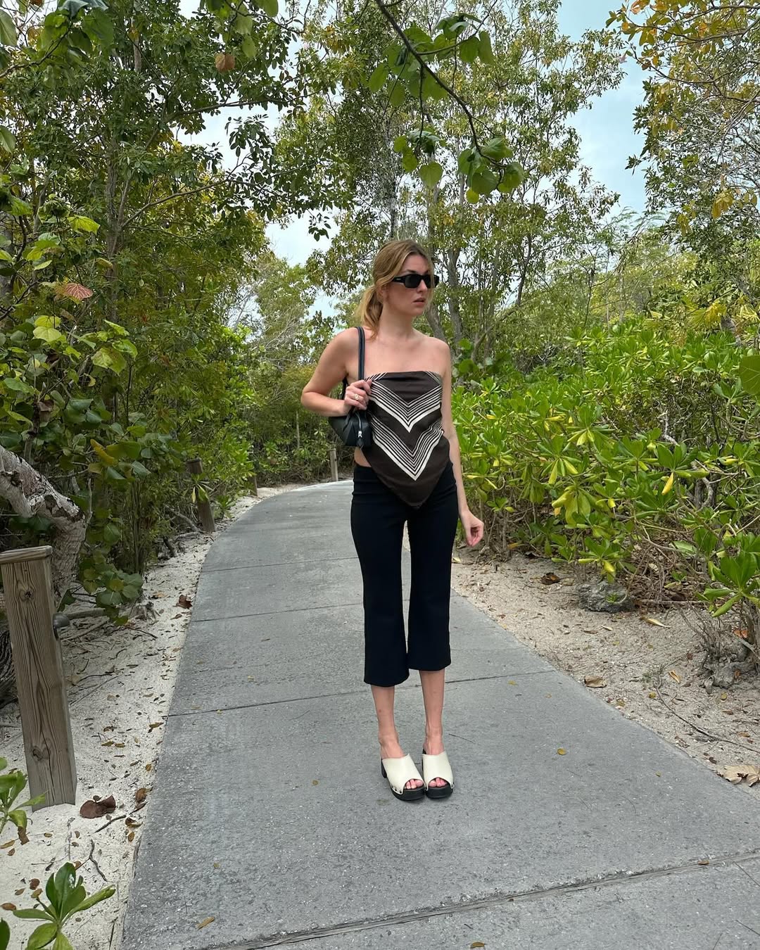 @camillecharriere wearing a scarf top and capri pants