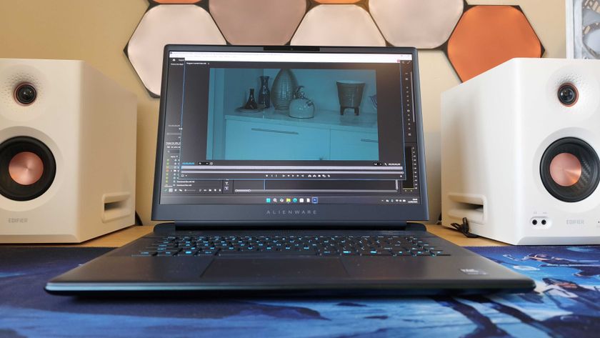 An Alienware 16 Area-51 laptop on a wooden desk