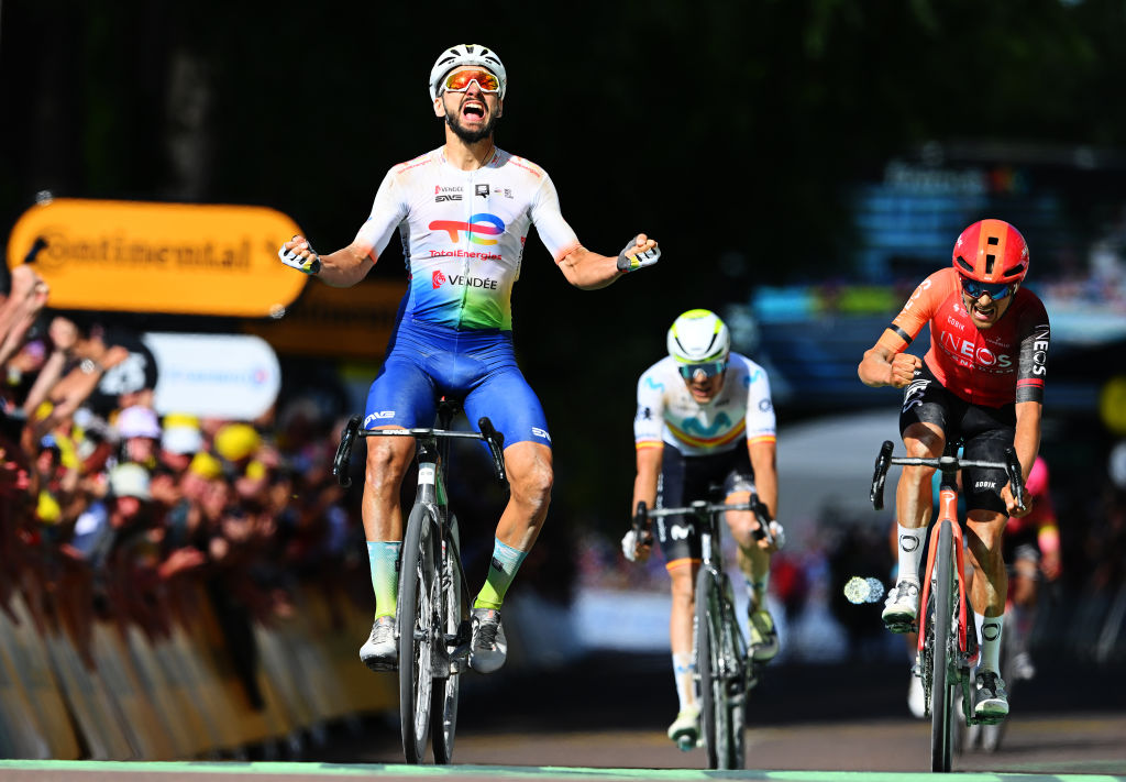 Anthony Turgis celebrates his 2024 Tour de France stage 9 win as Tom Pidcock bangs his bars in frustration