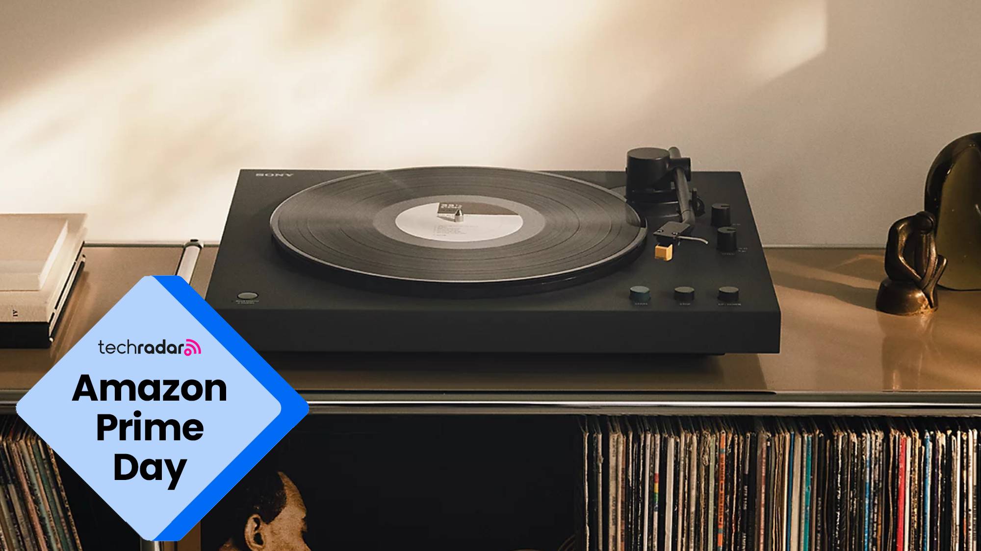 The Sony PS-LX5BT turntable on a countertop with vinyl records stored beneath