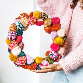 Christmas craft idea of making a colourful pom pom wreath