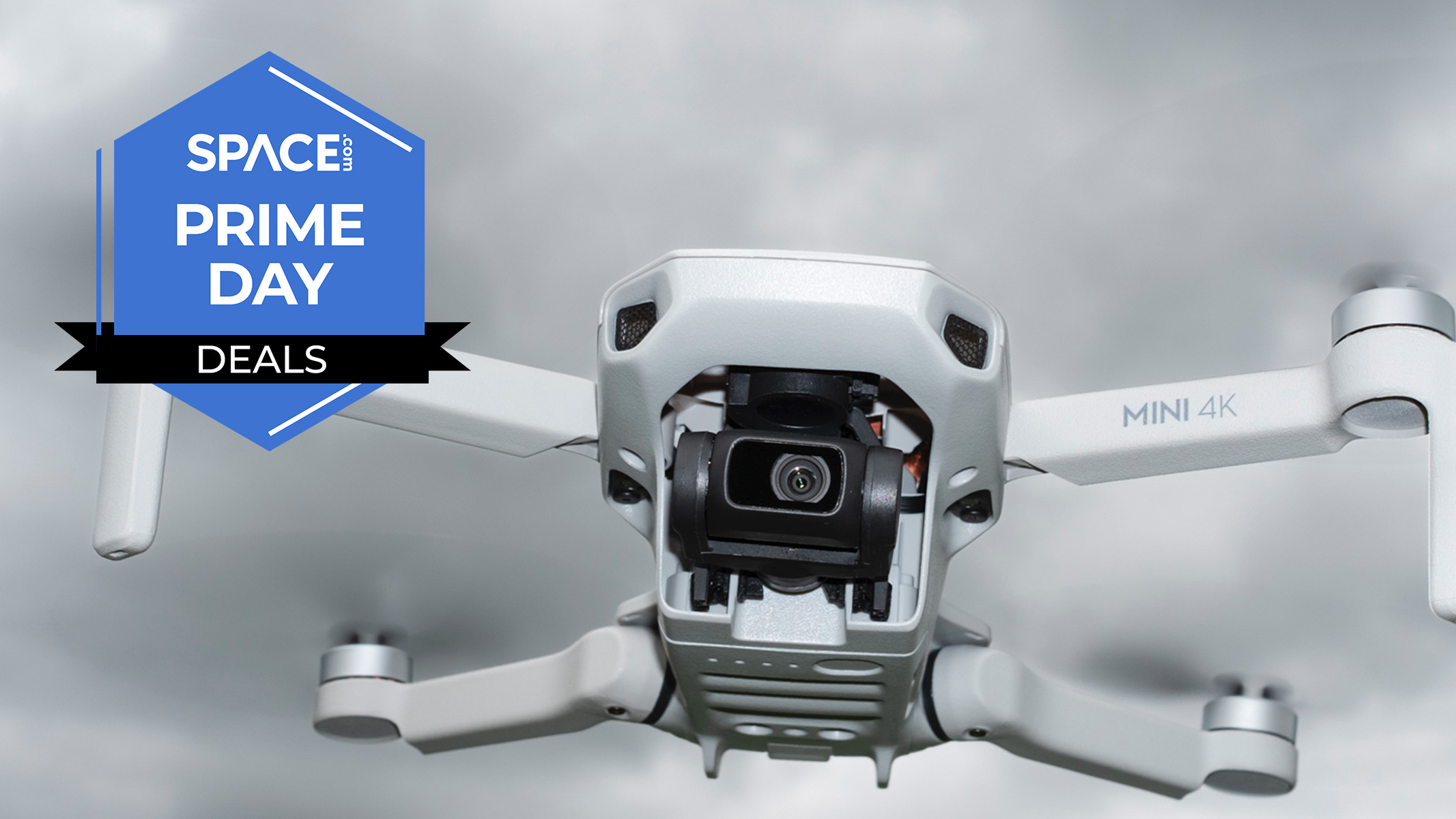 A DJI Mini 4K drone in the air, with clouds behind it. 