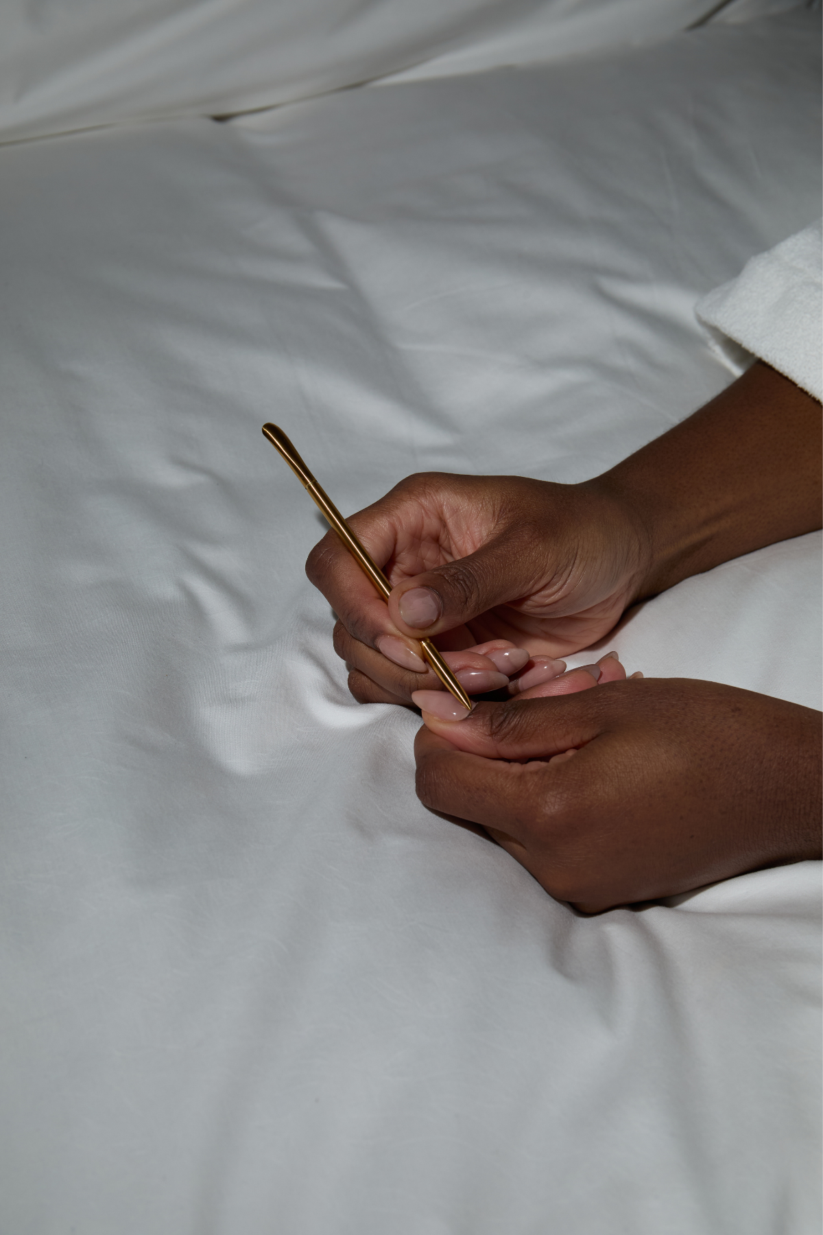 Hands using the navy cuticle pusher tool
