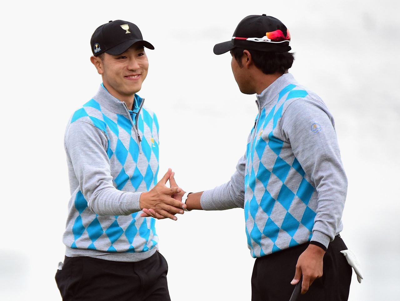 Sang-Moon Bae and Hideki Matsuyama of the International Team celebrate a birdie to win the hole on the 11th green during the Saturday four-ball matches at The Presidents Cup at Jack Nicklaus Golf Club Korea . Credit: Getty Images