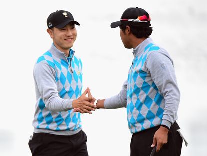 Sang-Moon Bae and Hideki Matsuyama of the International Team celebrate a birdie to win the hole on the 11th green during the Saturday four-ball matches at The Presidents Cup at Jack Nicklaus Golf Club Korea . Credit: Getty Images