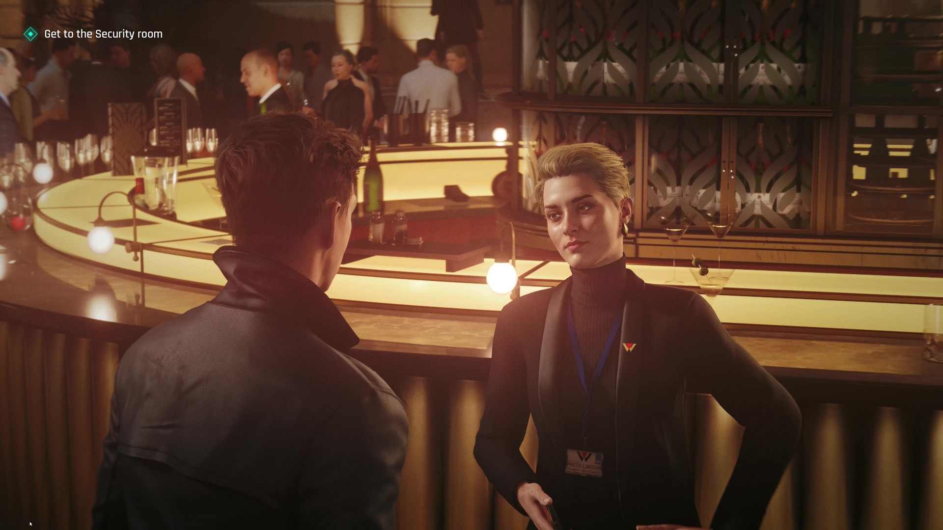 Bond speaks with a PR at the gala in 007 First Light