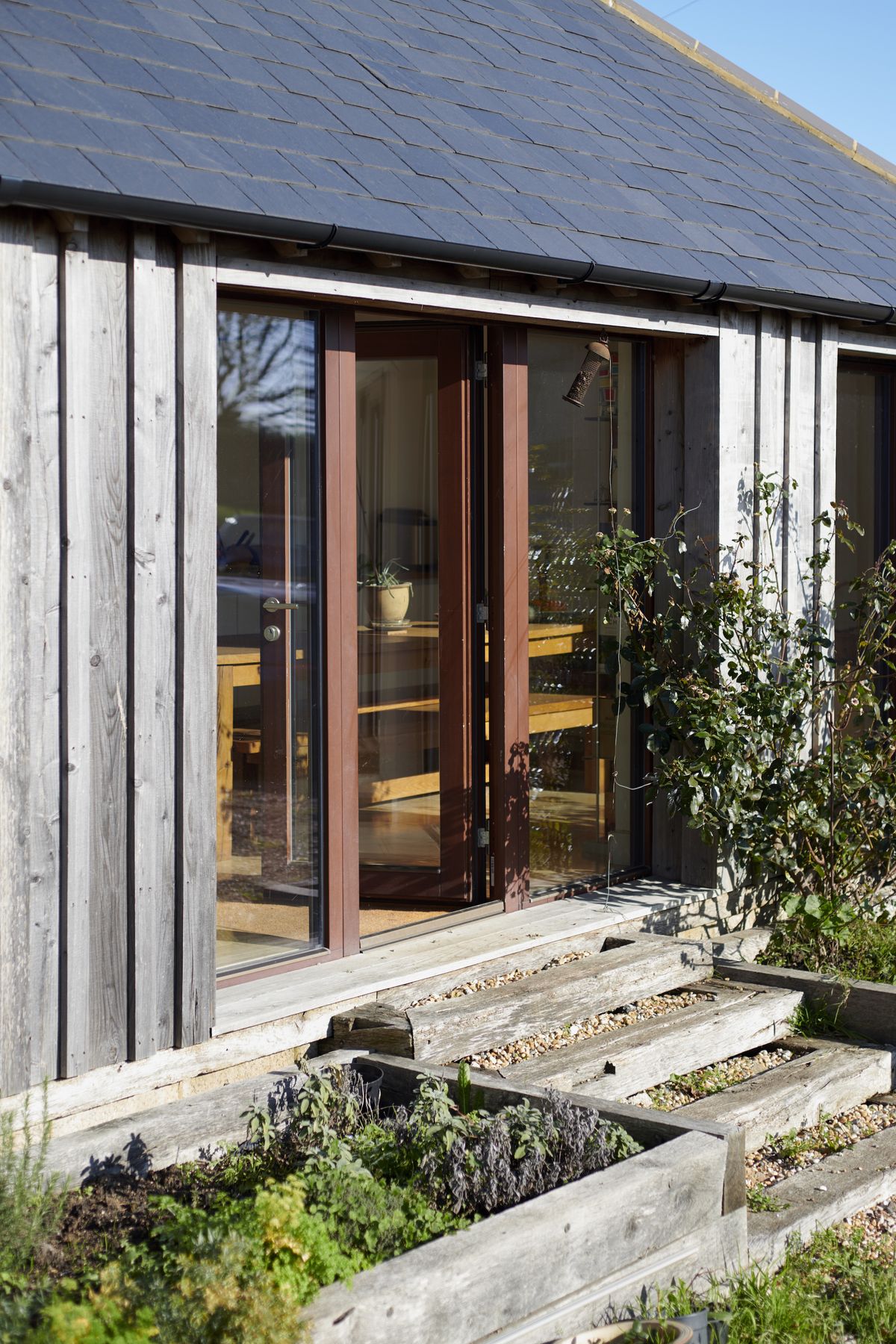 The windows and doors were specified in a dark-stained timber to complement the original brick barn
