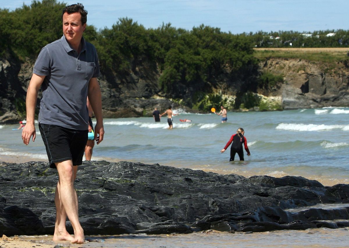 HARLYN BAY, UNITED KINGDOM - JULY 27: David Cameron walks on the beach at Mother Iveys Bay next to Harlyn Bay on July 27, 2008 in Harlyn, near Padstow, England. David Cameron, leader of the o