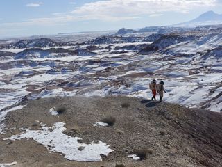 Crew 133 members Matthieu Komorowski (left) and Joseph Jessup walk towards the next stop on their geologic research tour near Utah's Mars Desert Research Station.