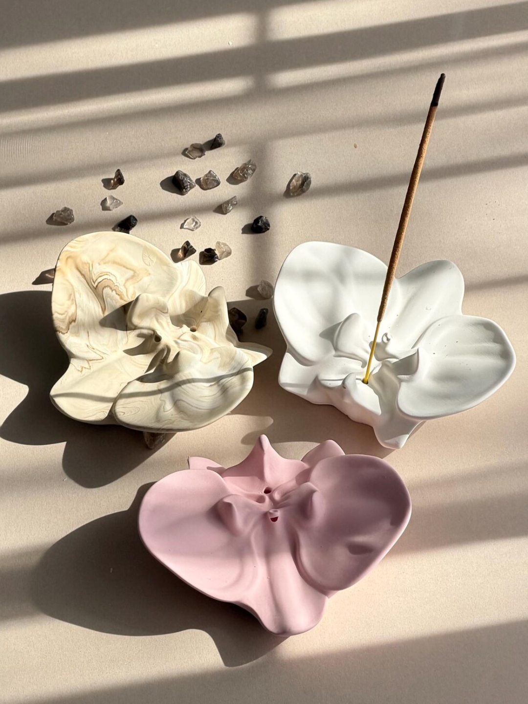 Three jesmonite orchid-shaped incense holders from Odyssey Interior
