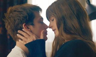 anne hathaway leans in to kiss nicholas galitzine in the movie the idea of you