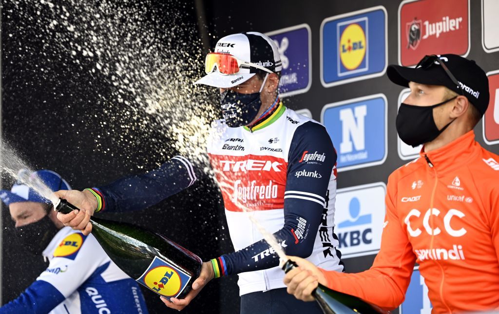 French Florian Senechal of Deceuninck QuickStep L Danish Mads Pedersen of TrekSegafredo C and Italian Matteo Trentin of CCC Team R celebrate with champagne on the podium of the GentWevelgem In Flanders Fields one day cycling race 2325 km in Wevelgem on October 11 2020 Photo by DIRK WAEM BELGA AFP Belgium OUT Photo by DIRK WAEMBELGAAFP via Getty Images