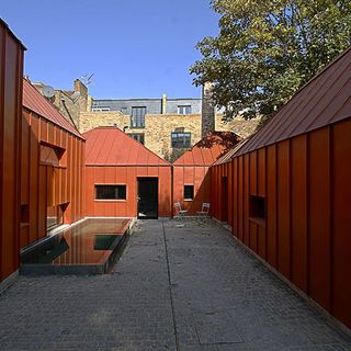 Exterior of house with red walls and sky