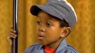 Emmanuel Lewis wearing a blue hat as Webster