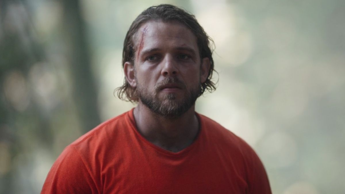 Max Thieriot standing in the forest as Bode