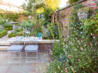 traditional garden with brick wall and cottage garden planting