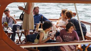 Jennifer Lopez and Ben Affleck take a cruise on the River Seine along with some of their children, Seraphina Affleck (front R) and Emme Muniz (front L) on July 23, 2022 in Paris, France.