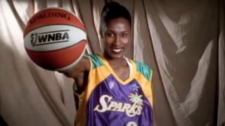 Lisa Leslie of the Sparks holds a WNBA basketball.