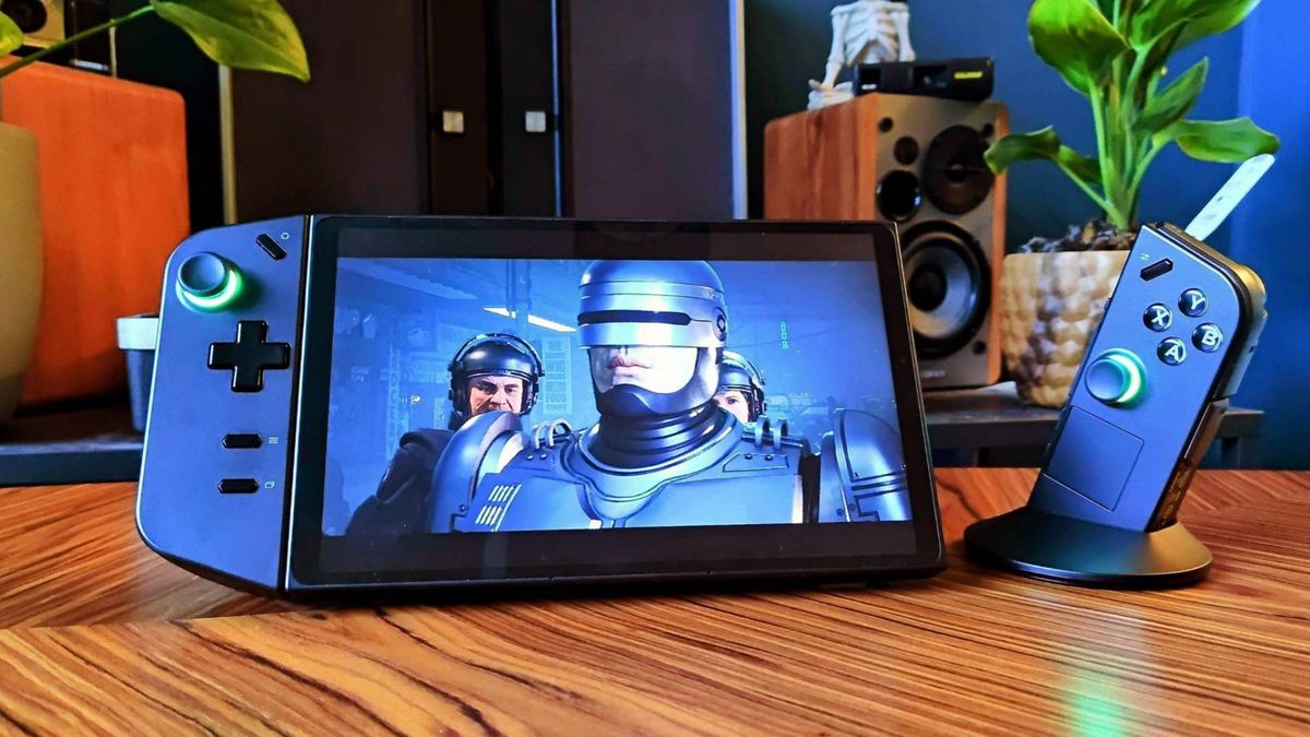 Lenovo Legion Go with right gamepad detached and on mouse mode puck sitting on coffee table with Robocop: Rogue City cutscene on screen.