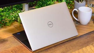 One of the best business laptops, A Dell XPS 15 (2022) on a wooden desk