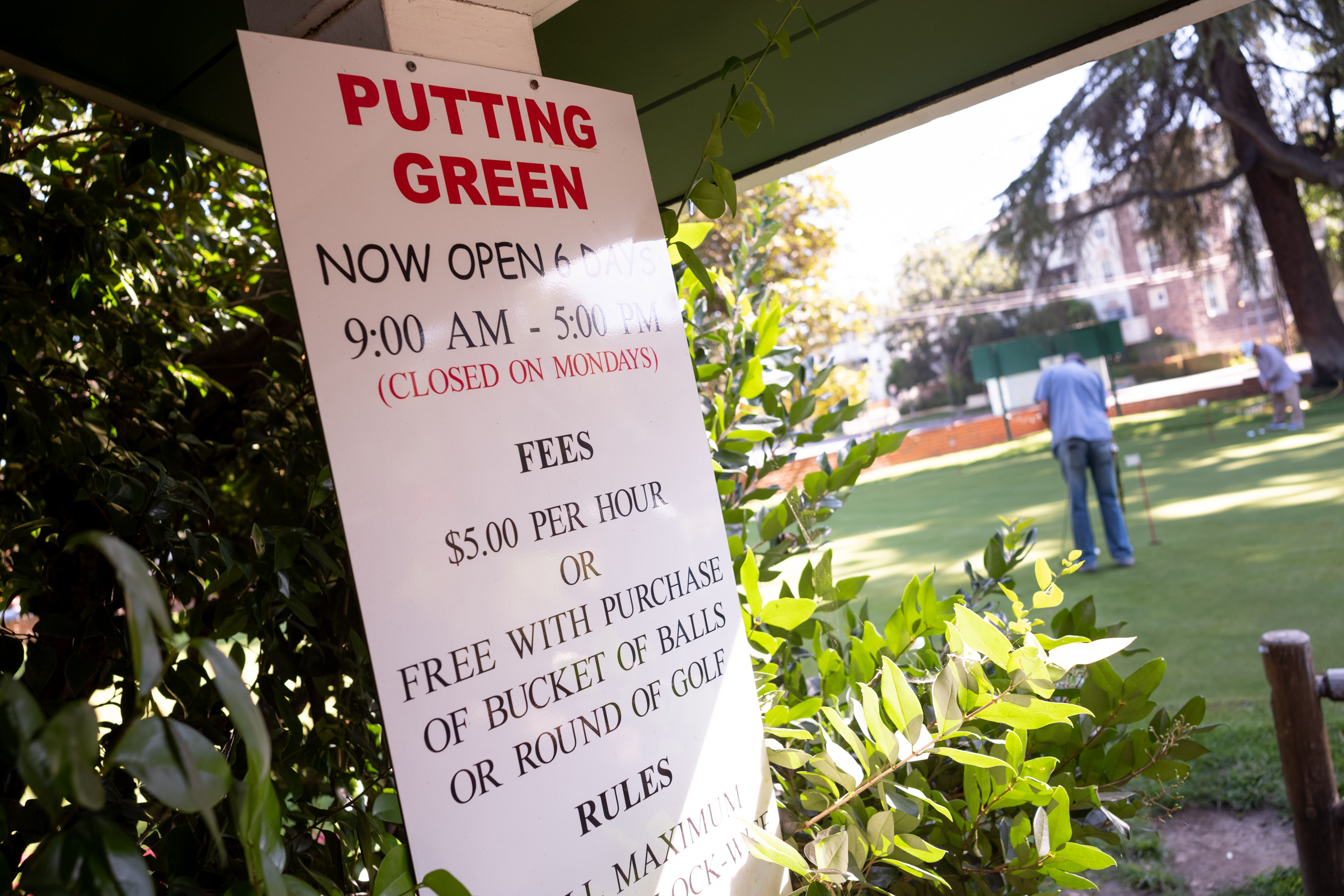Golfers practice on the putting green at the Weddington Golf Course in Studio City Friday