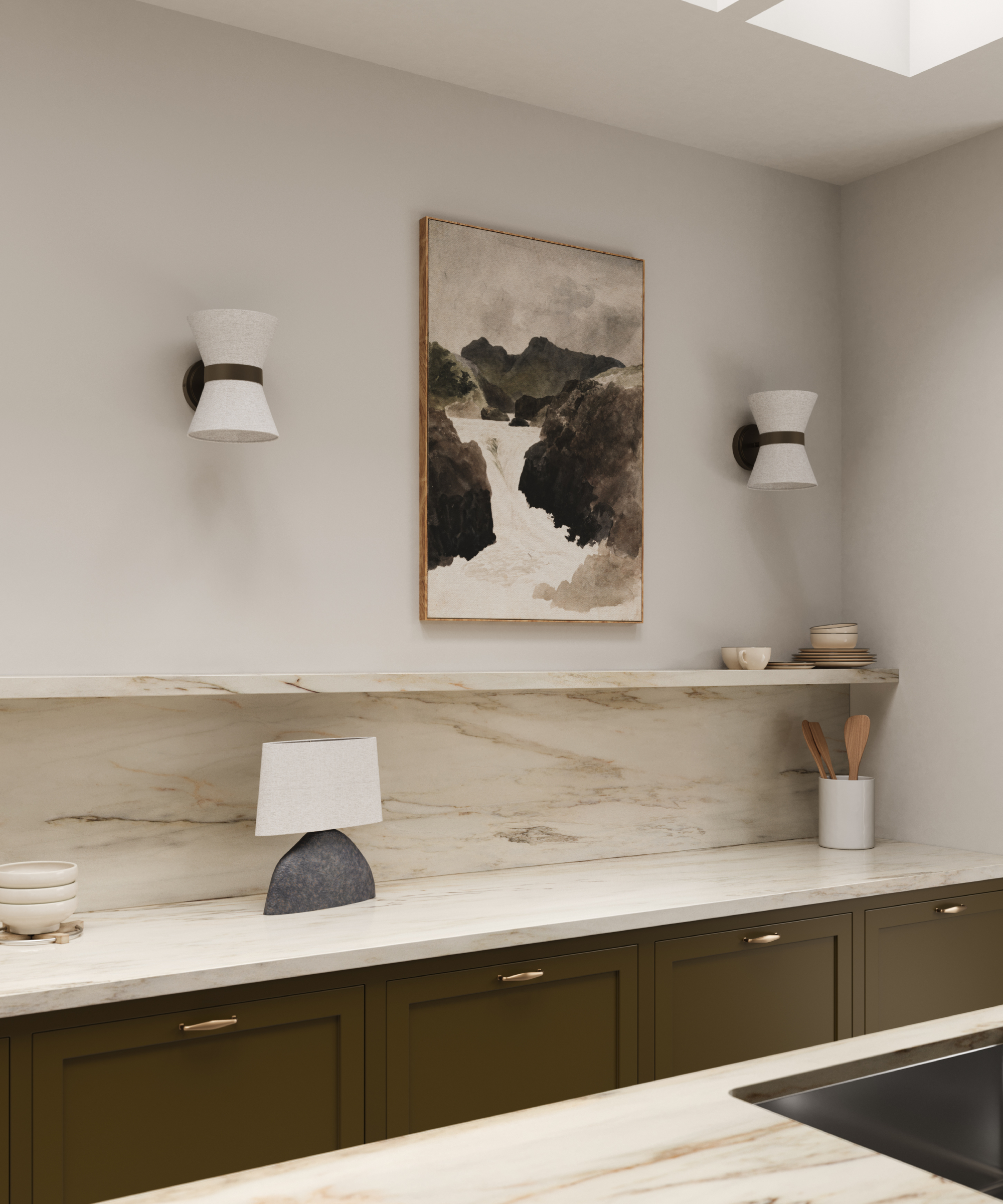 black and white wall lamps in kitchen either side of artwork with table lamp on worktop