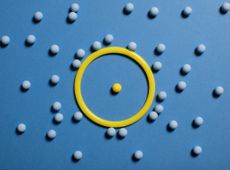 yellow circle surrounding yellow ball with blue background and blue circles surrounding it