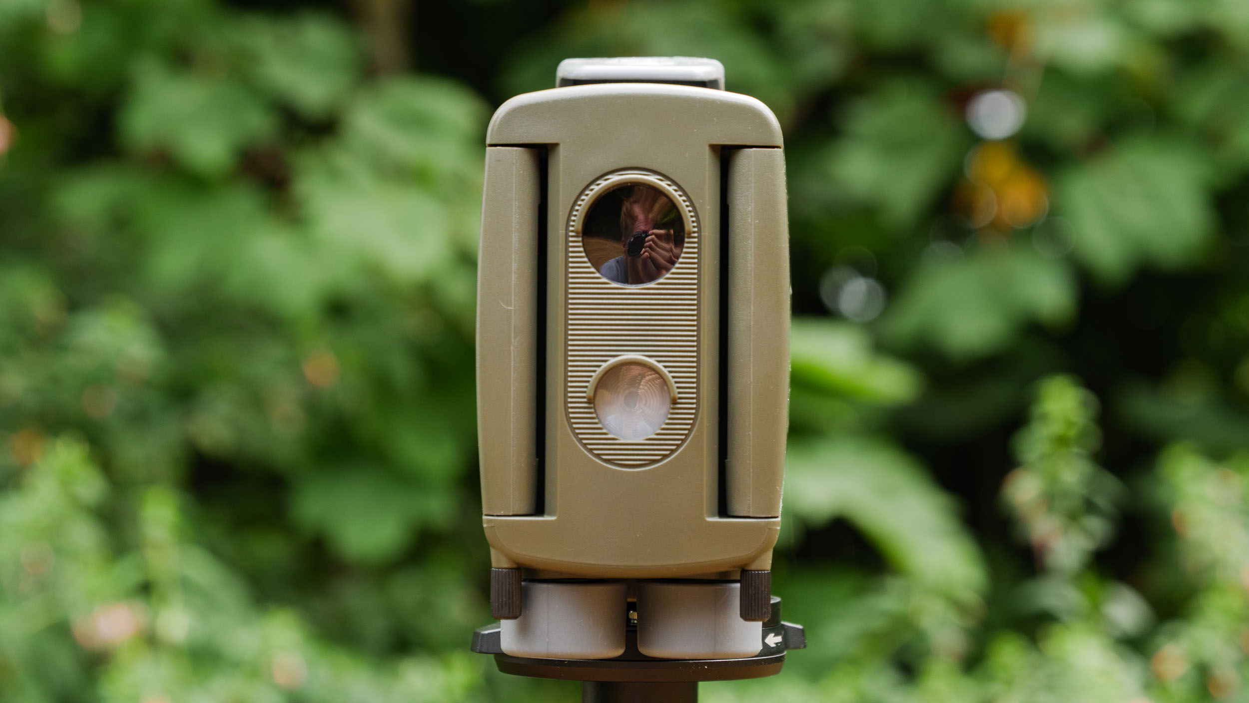 Camtraptions Camera Trap device outdoors with foliage backdrop