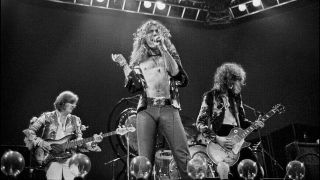 LED ZEPPELIN performing live on stage at Earls Court in London on 24th May 1975. Left to Right: John Paul Jones, Robert Plant and Jimmy Page.