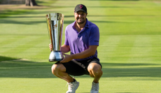 Peter Uihlein holds the International Series England trophy