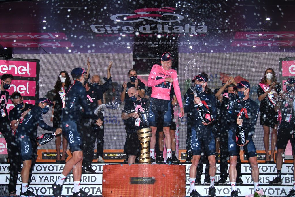 MILANO ITALY OCTOBER 25 Podium Tao Geoghegan Hart of The United Kingdom Jonathan Castroviejo of Spain Rohan Dennis of Australia Filippo Ganna of Italy Jhonnatan Prado Narvaez of Ecuador Salvatore Puccio of Italy Ben Swift of The United Kingdom Team INEOS Grenadiers Trofeo Senza Fine Trophy Celebration Champagne during the 103rd Giro dItalia 2020 Stage 21 a 157km Individual time trial from Cernusco sul Naviglio to Milano ITT girodiitalia Giro on October 25 2020 in Milano Italy Photo by Tim de WaeleGetty Images