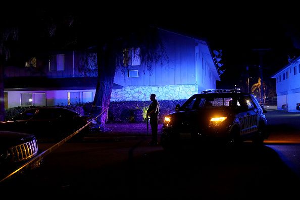 Police officers near the home linked to the San Bernardino shooting suspects.