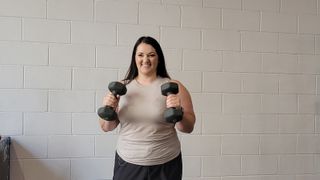 Personal trainer Rebecca Stewart performs a dumbbell hammer curl