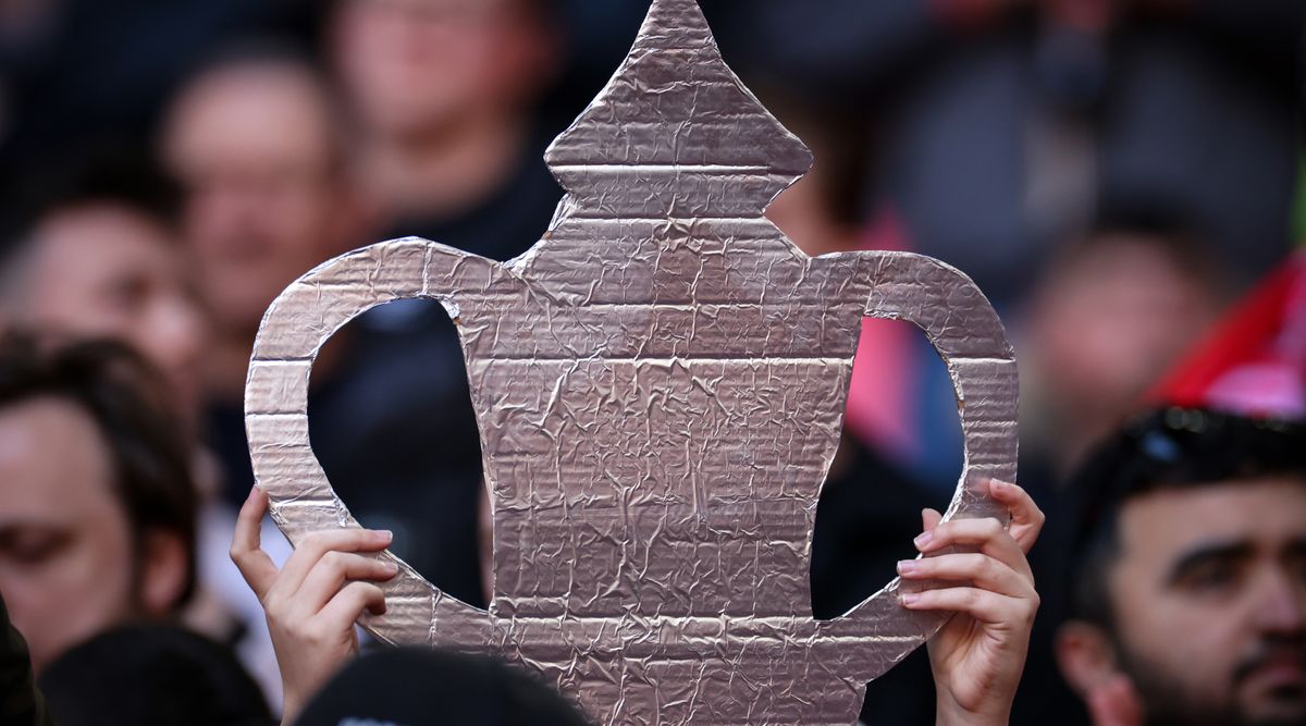 LONDON, ENGLAND - APRIL 22: A fan holds a tin foil FA Cup trophy during the Emirates FA Cup Semi Final match between Manchester City and Sheffield United at Wembley Stadium on April 22, 2023 in London, England. (Photo by Marc Atkins/Getty Images)