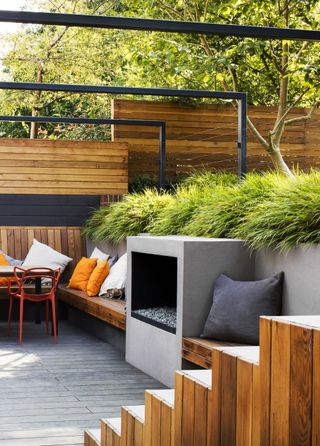 sleek fireplace built into a garden wall in a modern garden