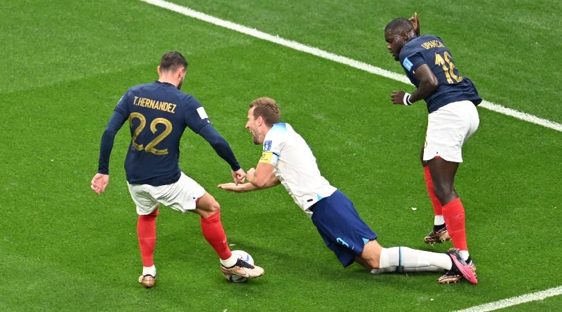 England captain Harry Kane goes down under a challenge from France&#039;s Dayot Upamecano during the teams&#039; World Cup 2022 quarter-final in Qatar.