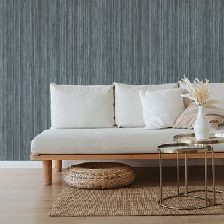 Grasscloth wallpaper behind couch in living room