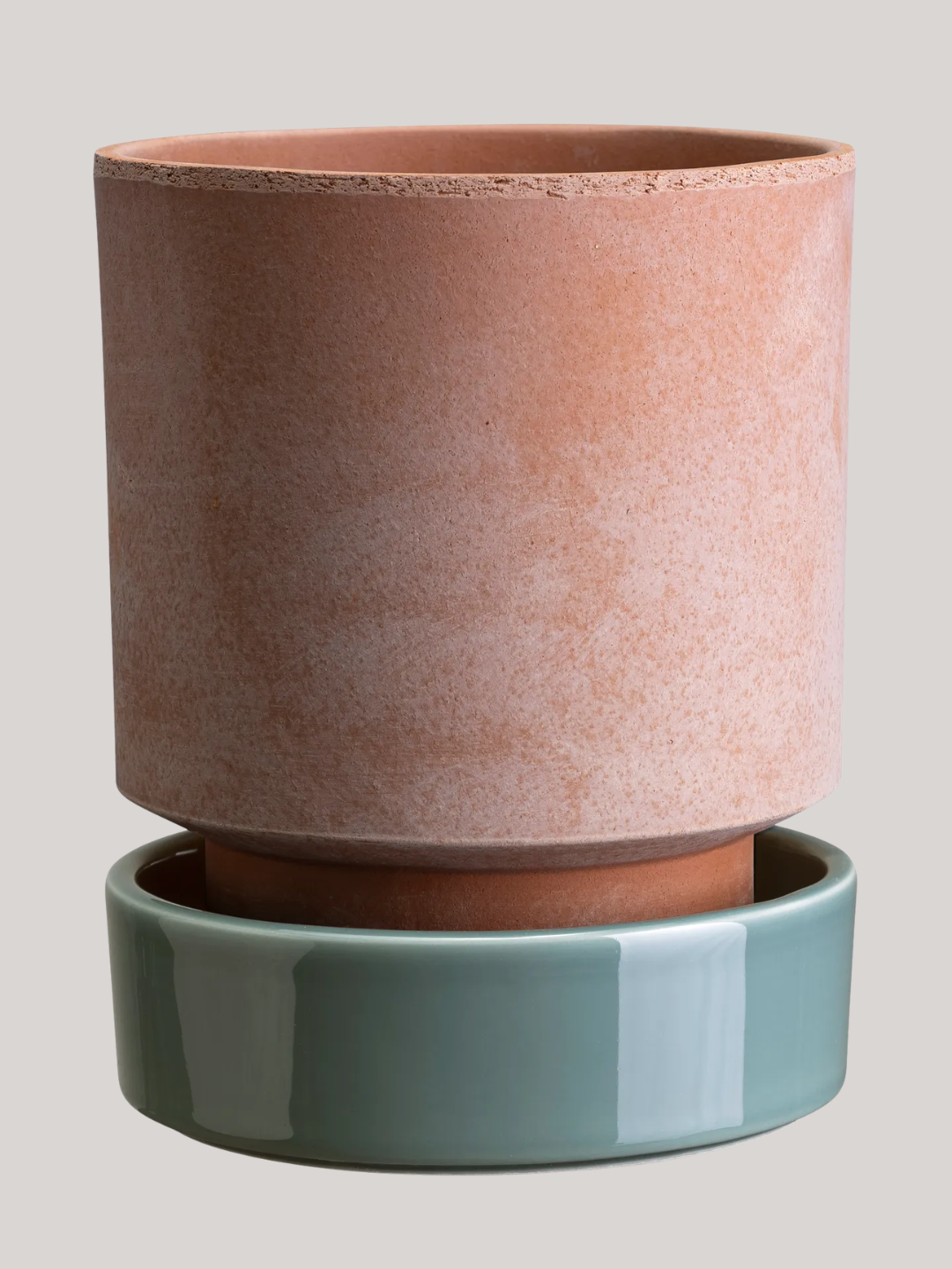 A terracotta planter with a glazed pale blue saucer from Bergs Potter