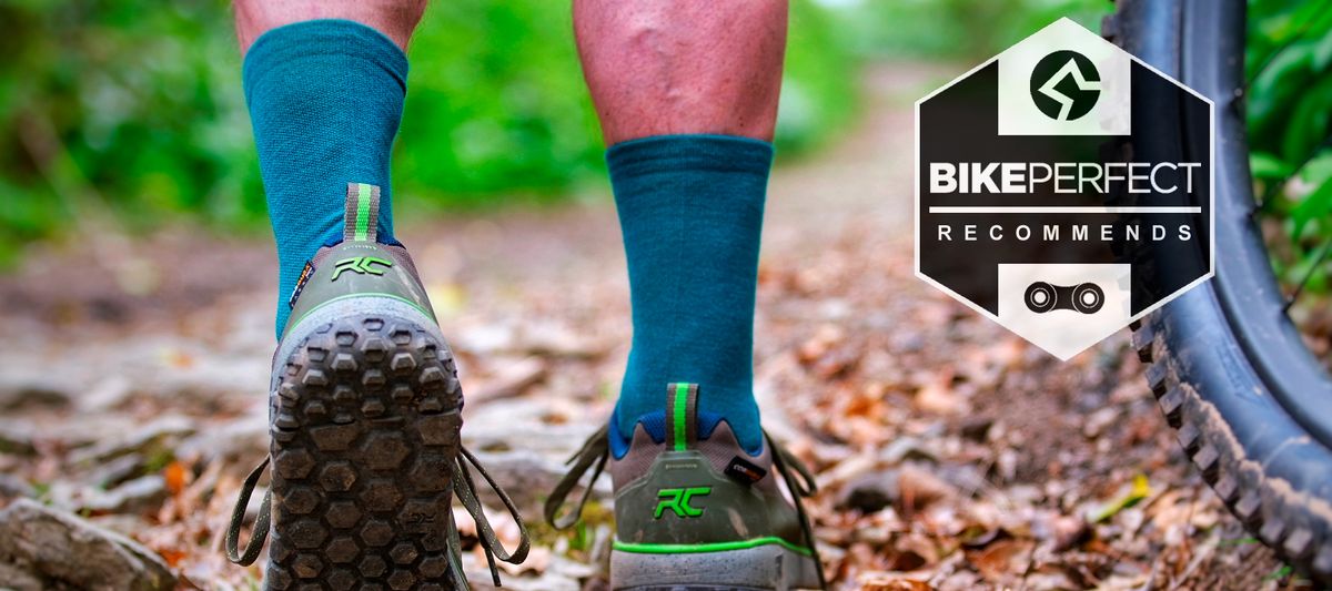 A close up of lower legs in cycling shoes and socks