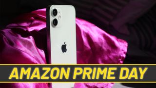 A photograph of the Apple iPhone 12 mini overlaid with a banner with text reading 'Amazon Prime Day'