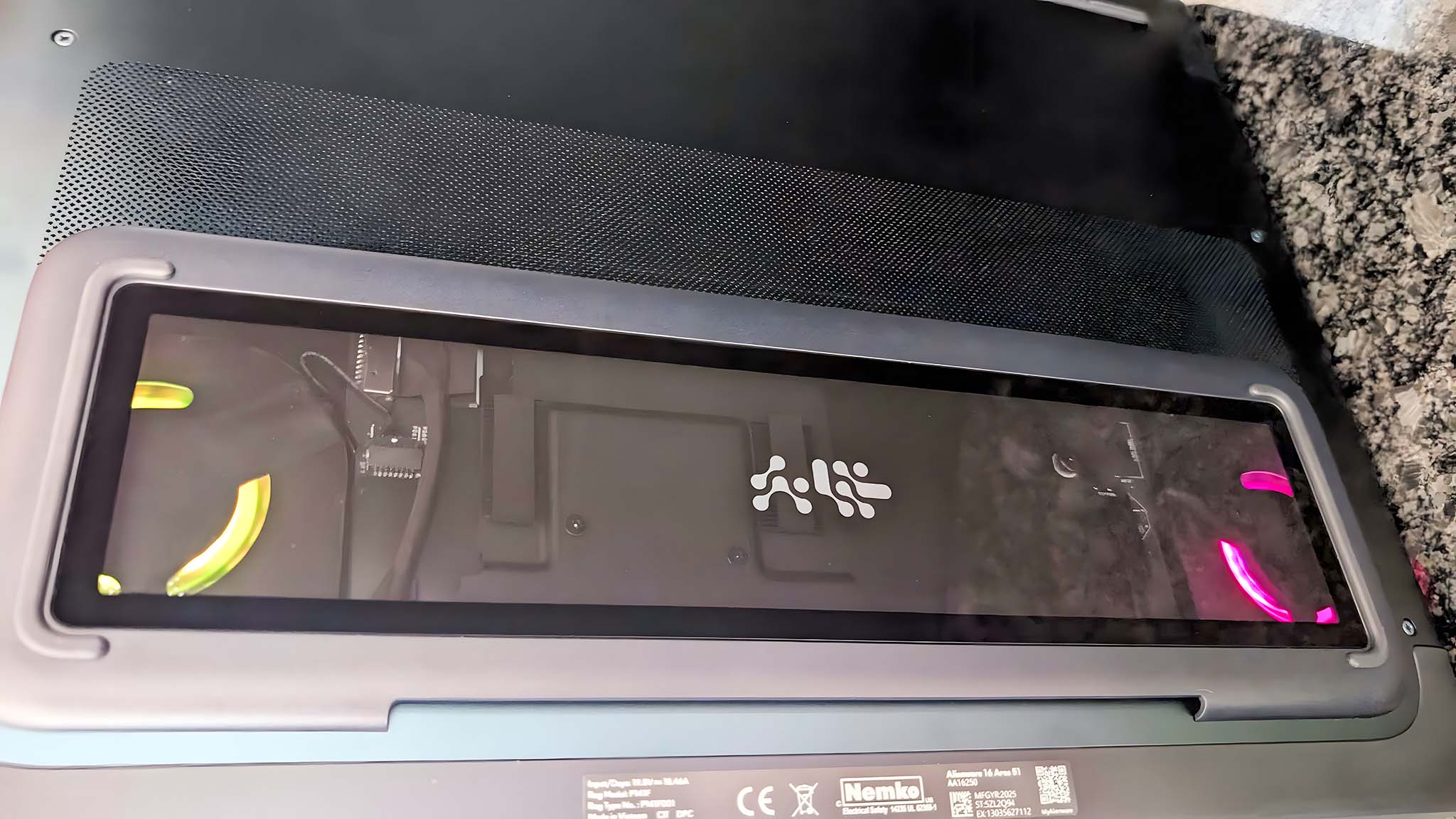 Underside of the Alienware Area-51 16 Gaming Laptop with fans highlighted with RGB lighting.