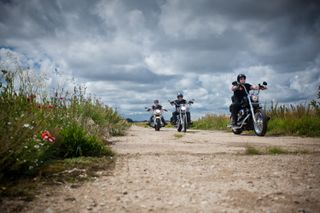 Three men on motorbikes