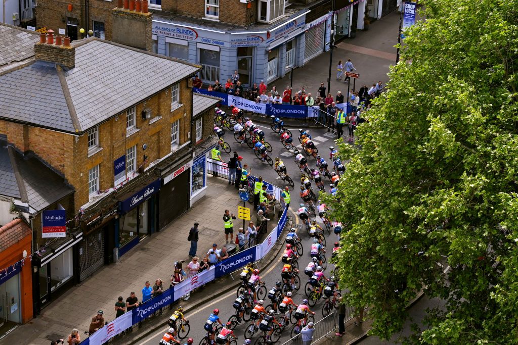 EPPING ENGLAND MAY 28 A general view of the peloton passing through Epping Village while fans cheer during the 5th RideLondon Classique 2022 Stage 2 a 1417km stage from Chelmsford to Epping RideLondon UCIWWT on May 28 2022 in Epping England Photo by Justin SetterfieldGetty Images